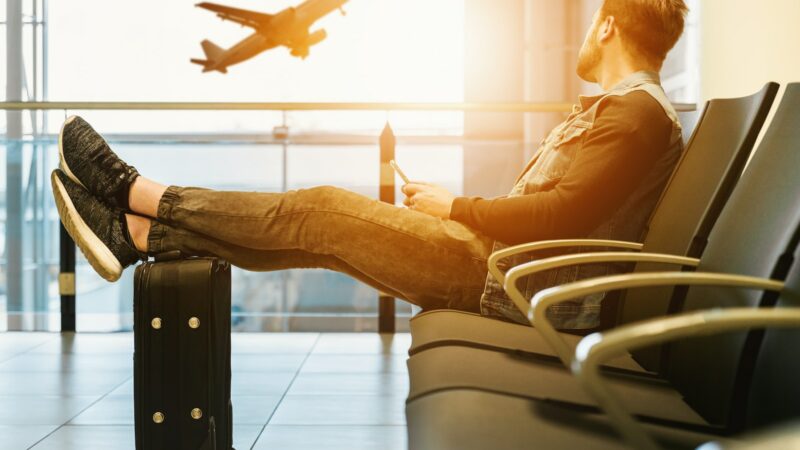 Man in airport waiting for boarding on plane