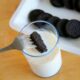 oreo dunk with fork into a glass of milk