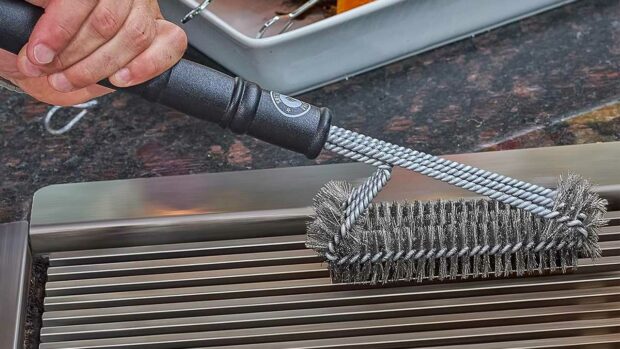 Cleaning A Grill Using A Grill Cleaning Brush.