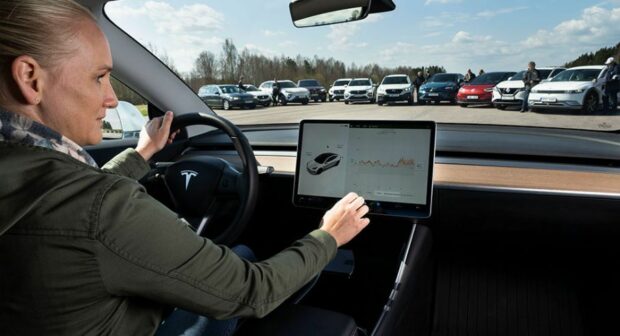 A Driver Learning How To Use Touch Screens In Cars
