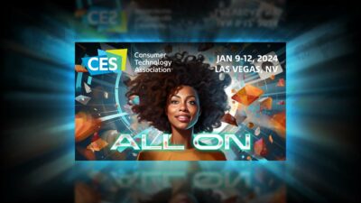 Best Of CES 2024 - A woman with afro hair is standing in front of a dark background, showcasing the future of entertainment with a transparent TV powered by AI at CES 2024.
