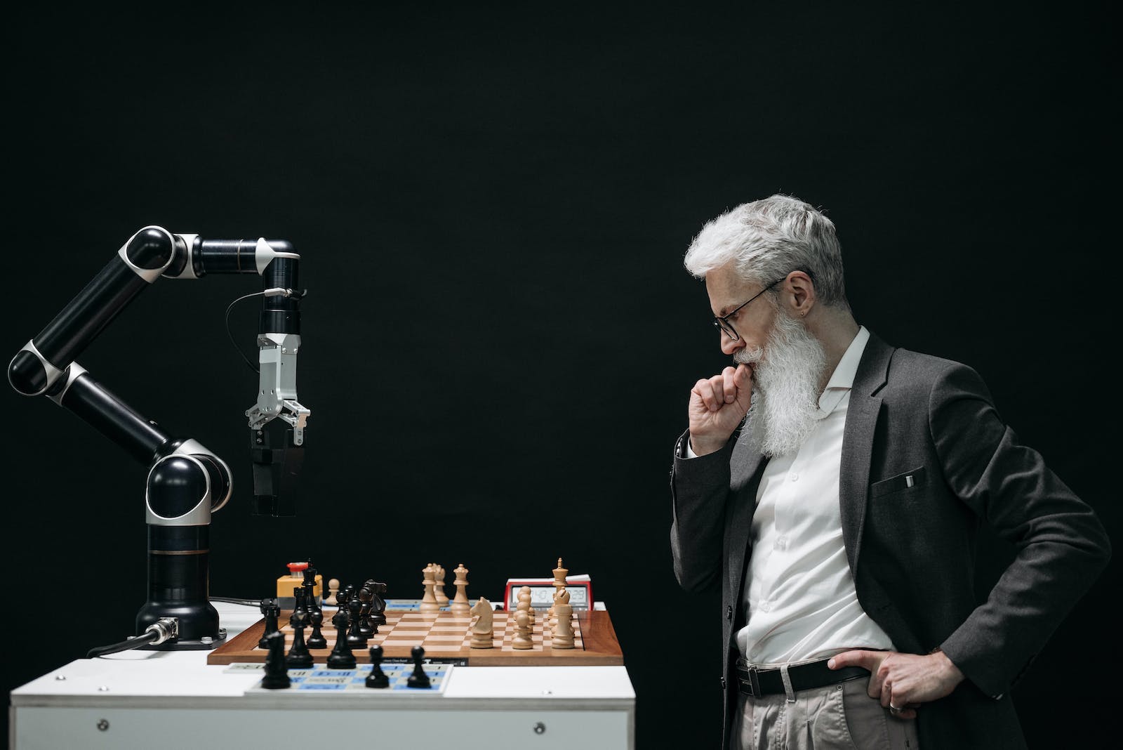 Elderly Man Thinking While Looking At A Chessboard -- Elderly Man Thinking While Playing Chess Against A Chessbot