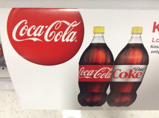 Sign With Coca-Cola Bottles With Yellow Caps