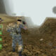 A soldier in a foggy valley from the video game Conflict Desert Storm.