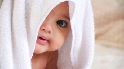 Cute Baby Wrapped In A White Towel