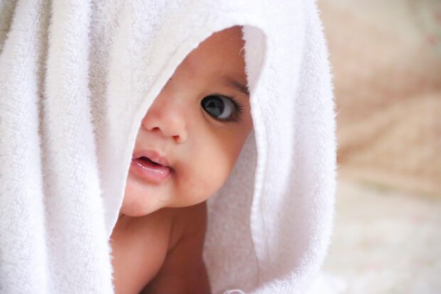 Cute Baby Wrapped In A White Towel