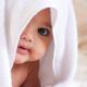 Cute Baby Wrapped In A White Towel