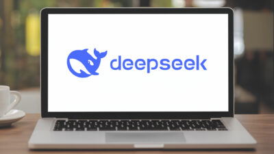 A laptop screen showcases the logo of a burgeoning Chinese AI startup: a majestic blue whale accompanied by the text "DeepSeek" in sleek blue font, signifying its innovation in the tech industry.