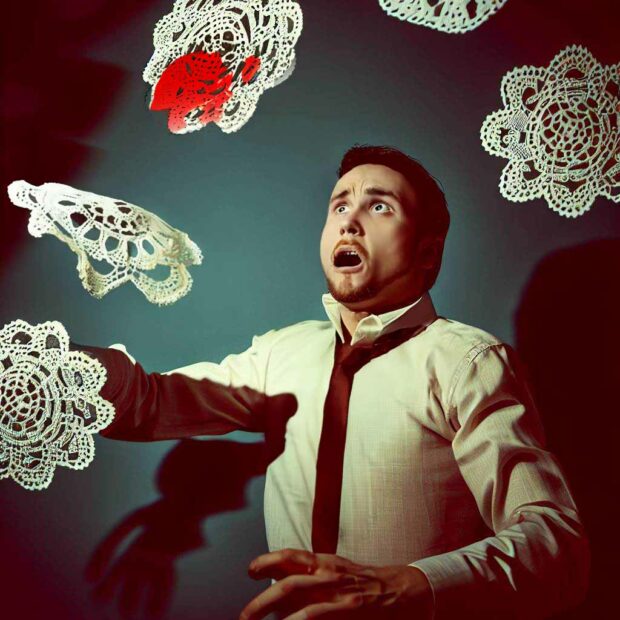 Flying Lace Doilies Attacking A Man Wearing A Tie