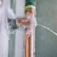 A frozen copper pipe has burst, spraying water horizontally due to the buildup of ice inside. This highlights the importance of winter safety and home protection measures to prevent such incidents.