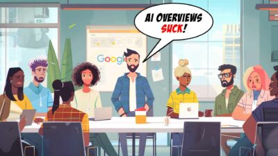 Google AI Overviews Suck - A diverse group of people is seated around a table in a modern office. One person, standing, has a speech bubble that reads, "AI Overviews Suck!" The Google logo is visible on a screen in the background, hinting at concerns over AI SEO and potential web traffic decline.