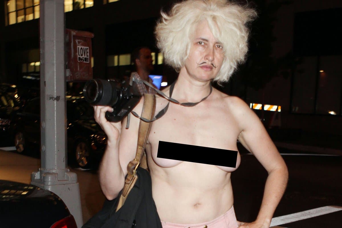 Who Is This Topless Photojournalist Roaming Manhattan?