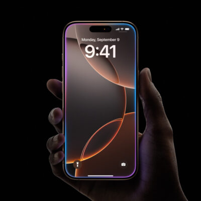 A Hand Holds A Smartphone Displaying 9:41 On The Clock And Monday, September 3 On The Screen. The Phone Has A Colorful Screen And A Black Background.