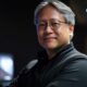 Jensen Huang, the ceo from nvidia - In a dimly lit setting, a person with glasses and gray hair stands confidently, donning a black jacket. The atmosphere hums with innovation, reminiscent of CES 2025.