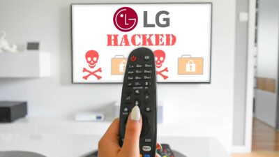 LG TV Hacked - A person holding a remote control aimed at an LG TV displaying "security update" with skull and lock icons.