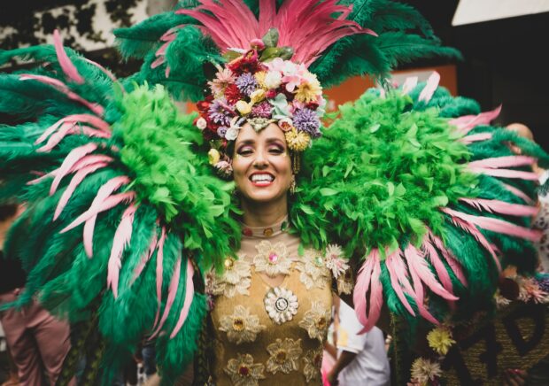 A Woman In A Green And Pink Costume For Mardi Gras