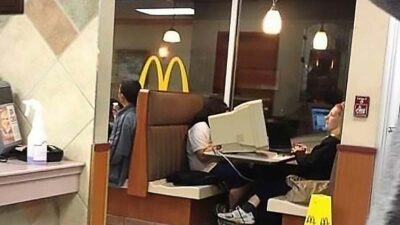 Woman Using Desktop Computer In A Mcdonalds Restaurant Booth