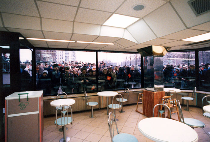 A Crowd Of People Look Inside The Window Of A Mcdonald'S Restaurant In Russia.