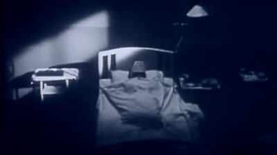 A black and white photo of a person in a hospital bed, reminiscent of the film "Johnny Got His Gun".