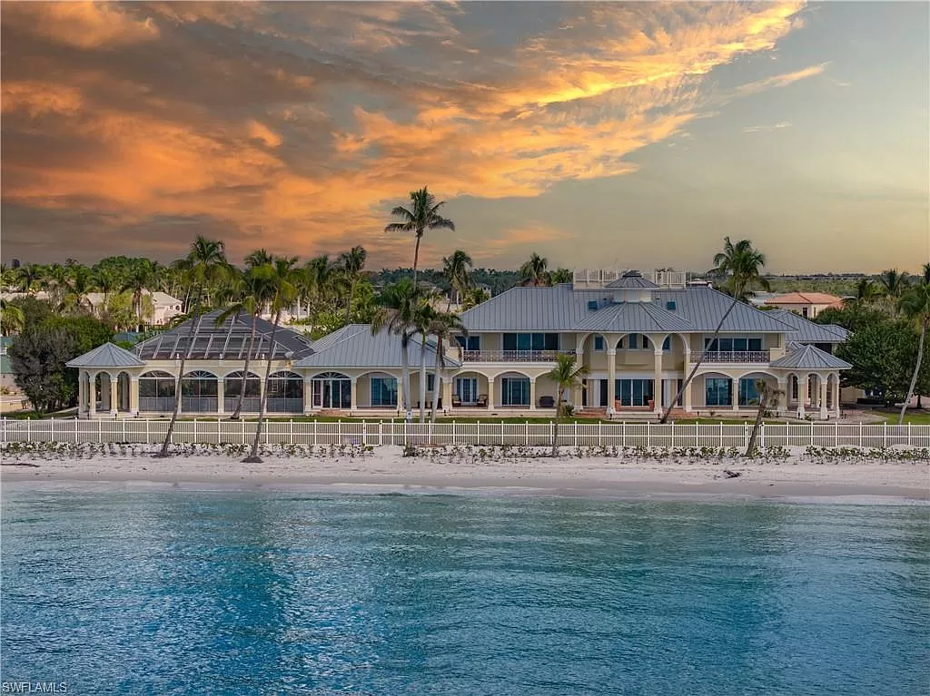 An Expensive Mansion On The Beach At Sunset.
