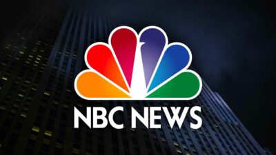 Nbc news logo with a building and Ann Curry in the background.