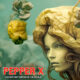 An image of a woman with a Pepper X hot pepper on her head