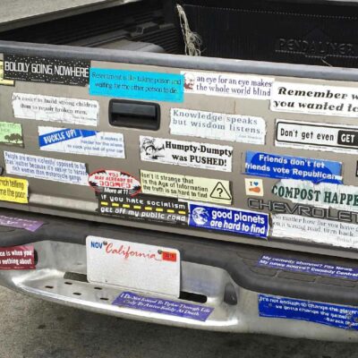 A Pickup Truck With Lots Of Bumper Stickers