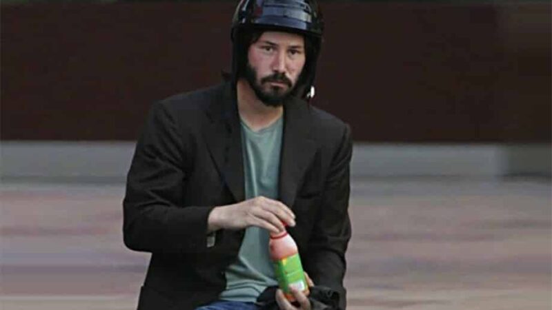Sad Keanu Reeves With Helmet And Juice