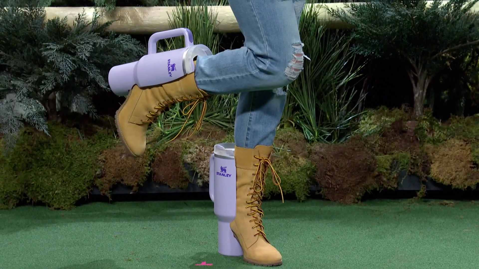 Ugg Stanley Cup - A Woman Wearing A Pair Of Boots And A Purple Watering Can In A Hilarious Snl Spoof.