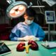 A teen selling kidney in an operating room so he can buy an iPad, iPhone and Apple MacBook laptop.