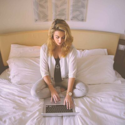 woman laptop bed