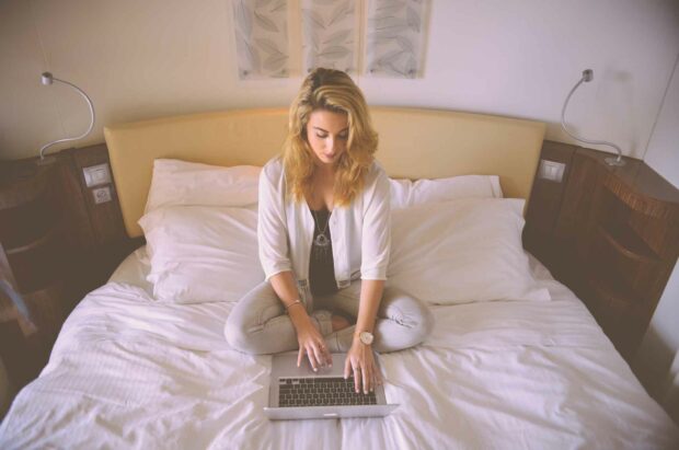 Woman Using A Laptop In Bed