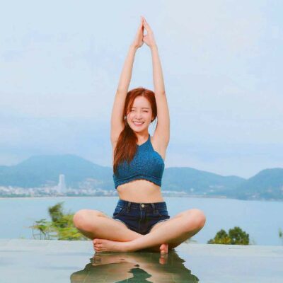 Young Woman Smiling While Doing Yoga