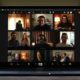 A Zoom video conference call with eight participants displayed on a laptop screen. Each person appears in their own window, engaging in conversation and sharing their thoughts on the latest changes.